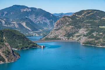 Fototapeta na wymiar Dam of the Lake of Serre-Poncon, one of the largest reservoirs in Europe, France