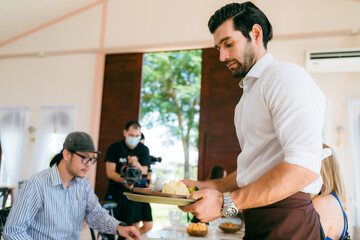 Engaging Service at the Eatery, Clients Enjoying Conversations while Waitstaff Attend, Cafe Scene Filled with Delicious Food and Beverages, Where Lifestyle Meets Business in Comfortable Dining
