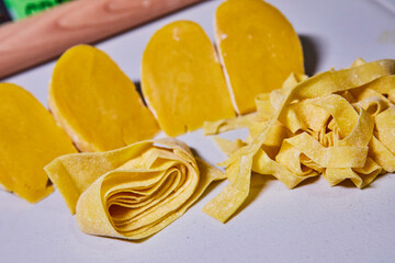 Handmade Pasta Variety with Dough Wedges in Domestic Kitchen
