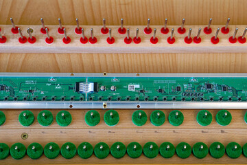 Close-up of green electronic part for silent piano upgrade functionality. Photo taken April 17th, 2024, Zurich, Switzerland.
