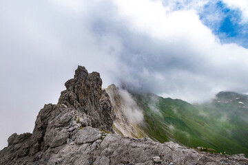 Fototapeta na wymiar Clouds Over the Rugged Cliffs and Steep Slopes of Gamsluggen by Lünersee