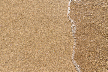 Beach sand background with calm waves
