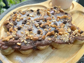 Chocolate greek yoghurt on top banana with mixed nuts and peach mixed strawberry yoghurt