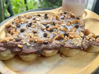Chocolate greek yoghurt on top banana with mixed nuts and peach mixed strawberry yoghurt