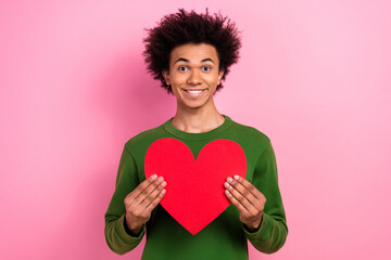Photo of happy positive guy hold red card heart present for valentine day isolated pastel color...