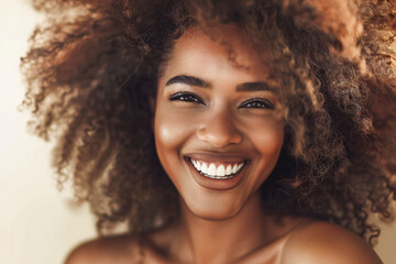Smiling woman with beautiful hair. Voluminous hair with healthy curls and beautiful hair color - obrazy, fototapety, plakaty