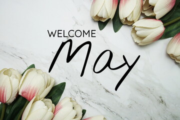 Welcome May text with Tulip flower border frame with space copy on marble background