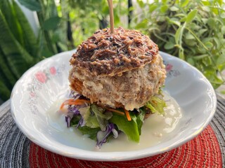 Crispy fried soft shell crab and rice berry burger with truffle sauce