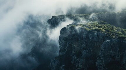 Cliff covered in descending fog