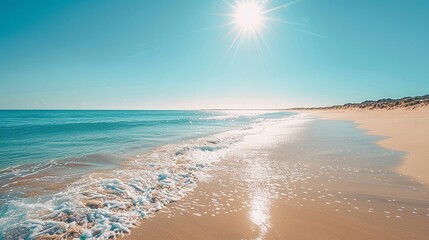 Pristine sandy beach stretching into the distance under a clear blue sky, sun shining brightly, summer vacation vibe