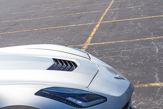 corvette copy space background super car on a parking lot, natural light authentic real life car