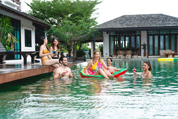 Summer Pool Party Fun: Friends in Swimwear Enjoying Happy Moments Together, A Group of Young Women and Men Creating Joyful Memories of Friendship and Laughter by the Water