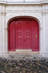 Elegant Red Door of a Traditional European Stone Building - obrazy, fototapety, plakaty