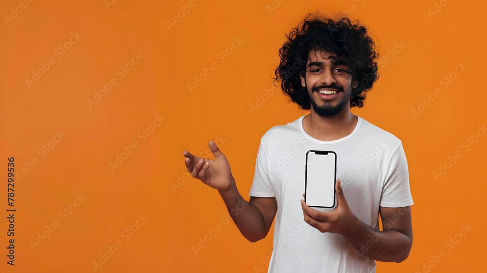 Aufkleber positive curlyhaired happy indian guy in white tshirt holds smartphone with mockup blank white scree