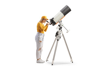 Young female observing the planets and stars with a telescope