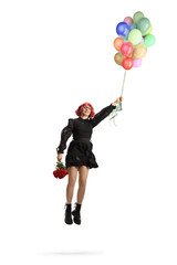 Woman in a black dress with red roses flying and holding a bunch of balloons - obrazy, fototapety, plakaty