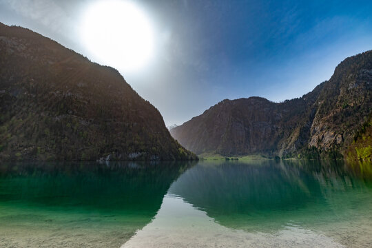Serene Spring Day at Lake K&ouml;nigssee: Crystal Clear Waters and Majestic Alpine Cliffs