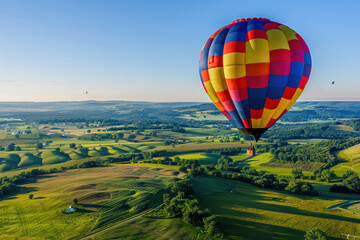 Obraz premium Hot Air Balloon Flying in the Sky Over Green Fields