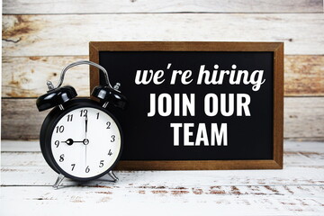 Join our team text message written on chalkboard with alarm clock