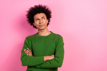 Photo of doubtful guy crossed hands look empty space solving isolated pastel color background