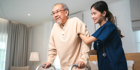 Obraz premium Asian physiotherapist nursing home to support old senior man patient therapy by walker, caregiver nurse help recovery health care with elderly retirement man person at home, health insurance concept
