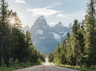 Cercles muraux Chaîne Teton An open road leads to the Grand Teton's mountain range, rising in the distance. Trip concept.