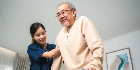 Asian physiotherapist nursing home to support old senior man patient therapy by walker, caregiver...