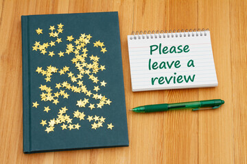 Please leave a book review with retro old blue book on a desk with stars - 787311559