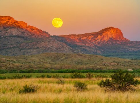 Sunset landscape with a full moon in Wichita Mountains National Wildlife.