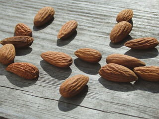 Almond nuts on grey wooden table background. Almond nuts on a wooden desk