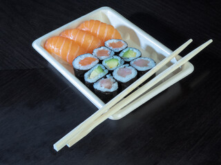 Sushi tray on black wood