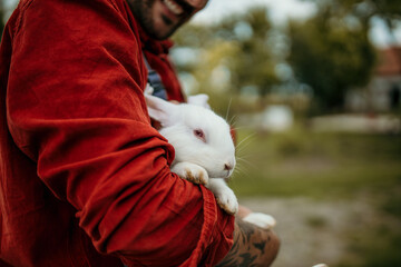 Male farmer holding a domestic rabbit