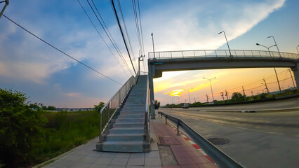 The road in the evening has the sun setting.