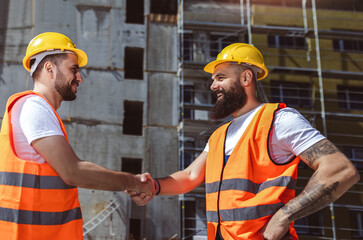 Contractor. construction worker team hands shaking after plan project contract  at construction site, contractor, engineering, partnership, construction concept - 787319106