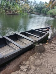 Obraz premium A canoe is a lightweight narrow water vessel, typically pointed at both ends and open on top, propelled by one or more seated or kneeling paddlers facing the direction of travel and using paddles.