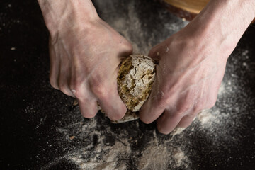 male hands kneading dough from rye flour for baking bread or pizza