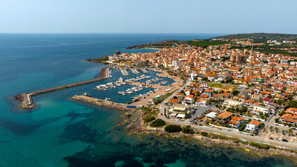 Aerial view of Portoscuso, an Italian municipality in the province of Southern Sardinia, Italy. The town, built on the sea, also has a small port that is very active in the summer season.