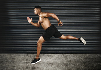 Body, black man or running at speed, fitness or workout of exercise, energy or cardio for health. Strong, muscular or male runner on dark background, training and wellness routine for performance