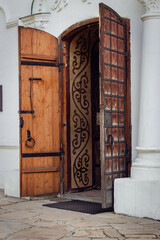 Open wooden door to the church. St.Cyril church exterior. Ancient doorway to cathedral. Ukrainian historical church. Come to God concept. Vintage wooden entrance to the dome. Religious architecture.  - 787334126