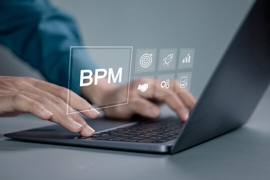 BPM, Business process management concept. Business data analytics and business strategic planning. Businessman using laptop with BPM icon on virtual screen.