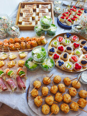 Catering buffet for events. Catering banquet table with different food snacks and appetizers with sandwich, salads, fresh fruits.