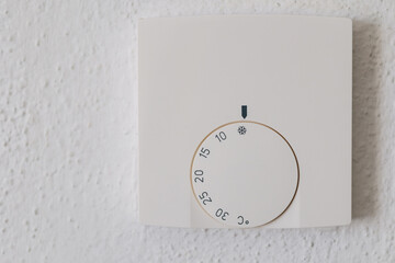  Thermostat with the external and target temperatures indicated. Rotary dial to control and adjust....