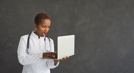 African American female doctor, student or intern with a scared and surprised face looks at a...