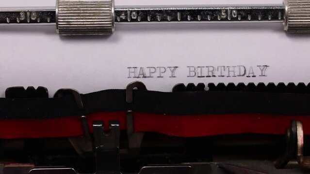 large flowing text HAPPY BIRTHDAY written with old typewriter with black ink
