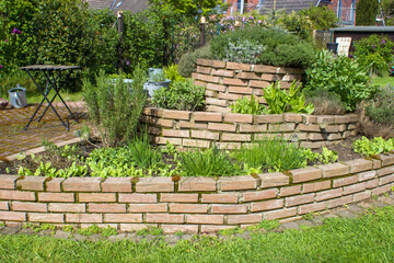 herb spiral in the garden with fresh herbs - 787340321