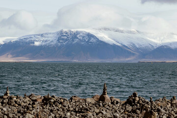 landscape of stacking stone at coast with snow mountain in Iceland 
