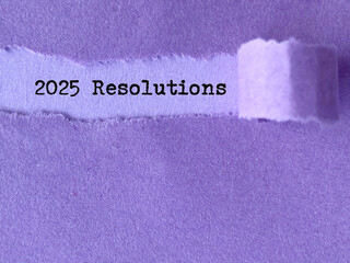 New Year Concept - 2025 resolutions behind torn paper background. Stock photo.
