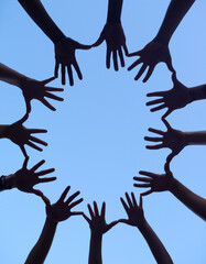Hands, group and silhouette for support huddle, low angle of collaboration for team building and...