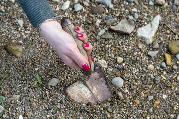 Dirty woman's hand working in the vegetable garden with a trowel. Well-groomed female hands soiled with dirt.