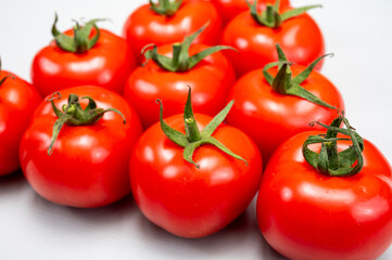 Food triangle, Red ripe tasty Dutch tomatoes, vegetables background top view close up